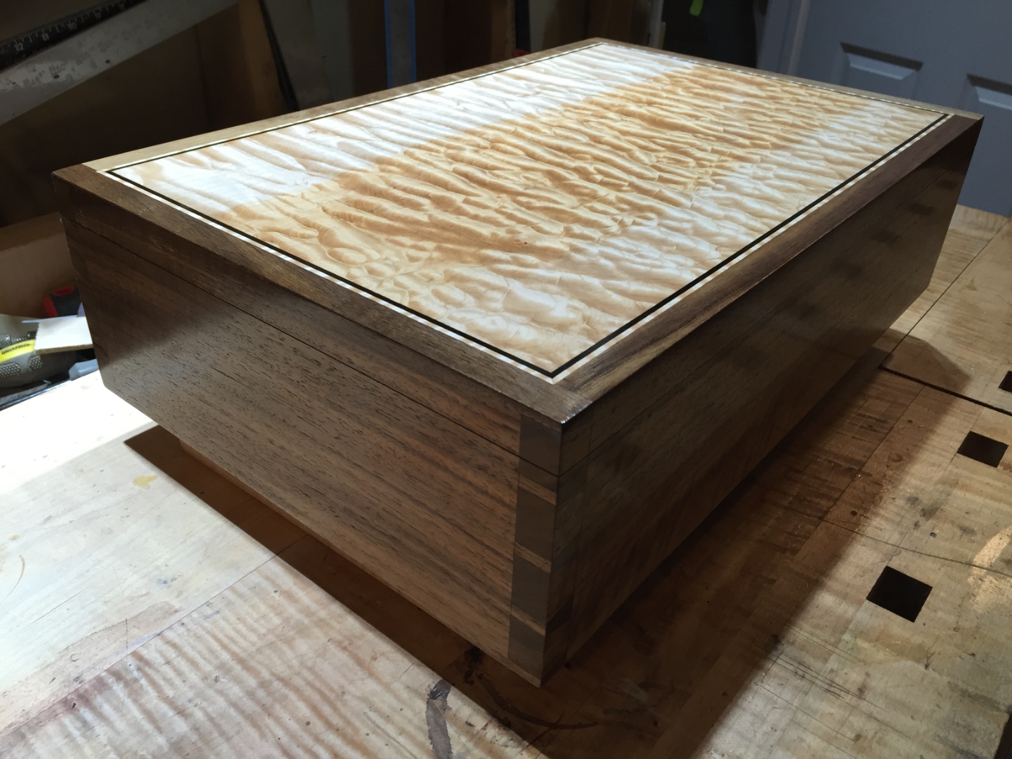 Quilted maple lid inset in a curly walnut carcass with ebony inlay.