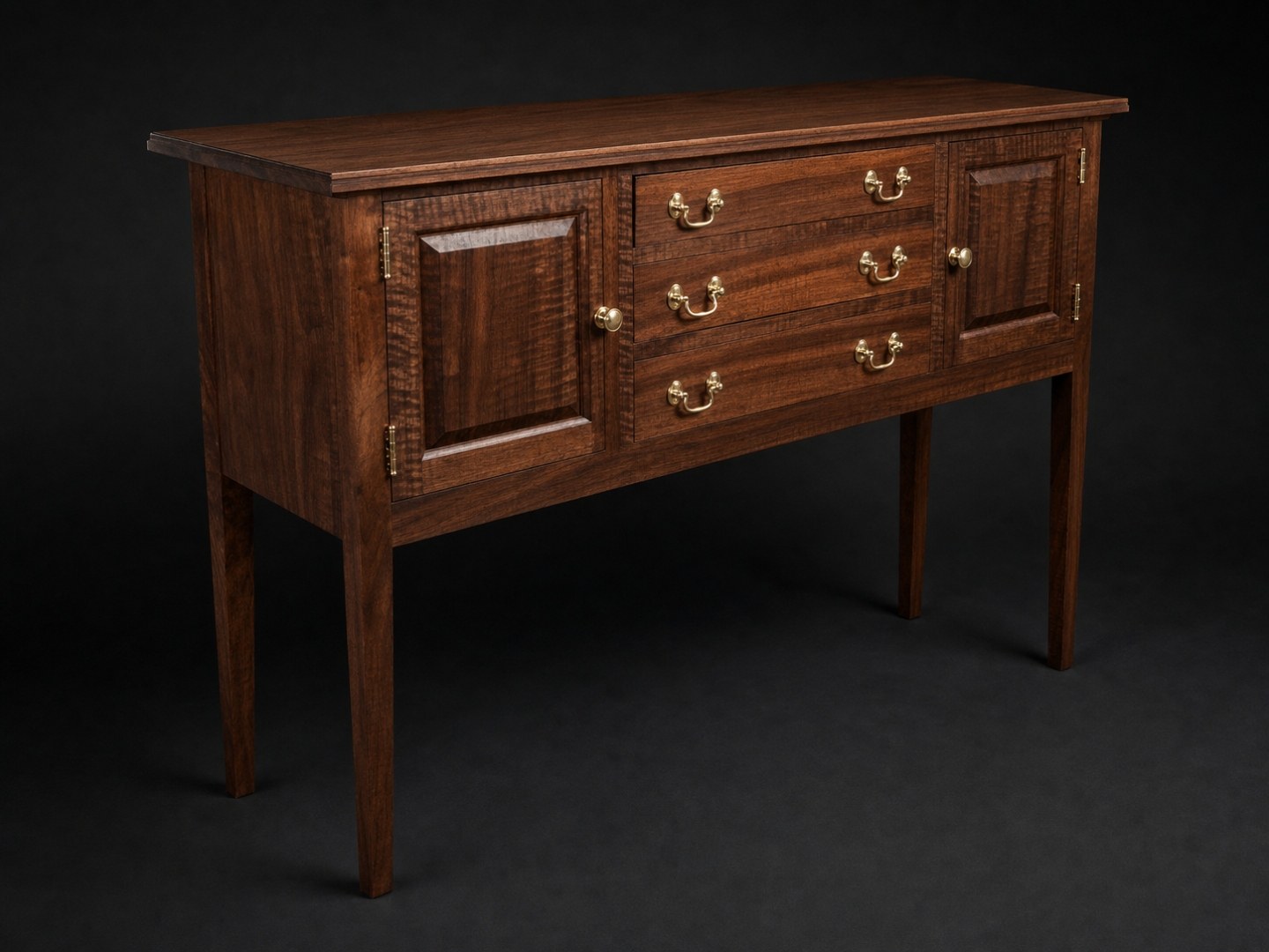 Curly walnut sideboard with tiger maple drawer fronts, on studio black.