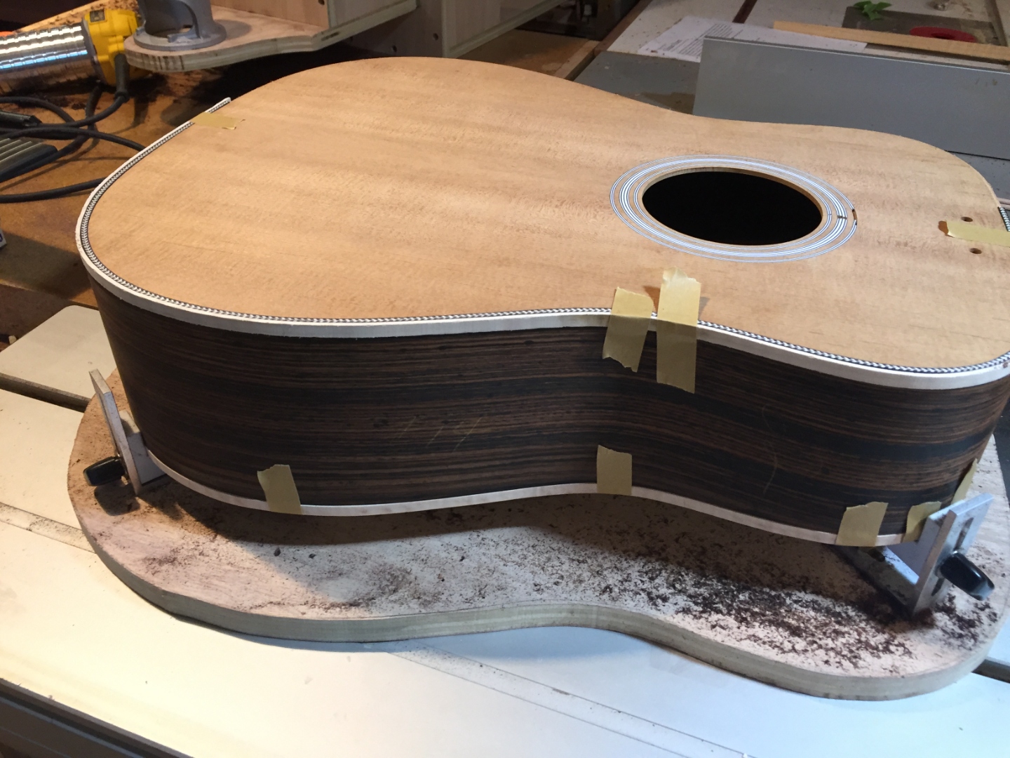 Dreadnought guitar body glued up on the bench — spruce top on ebony sides.