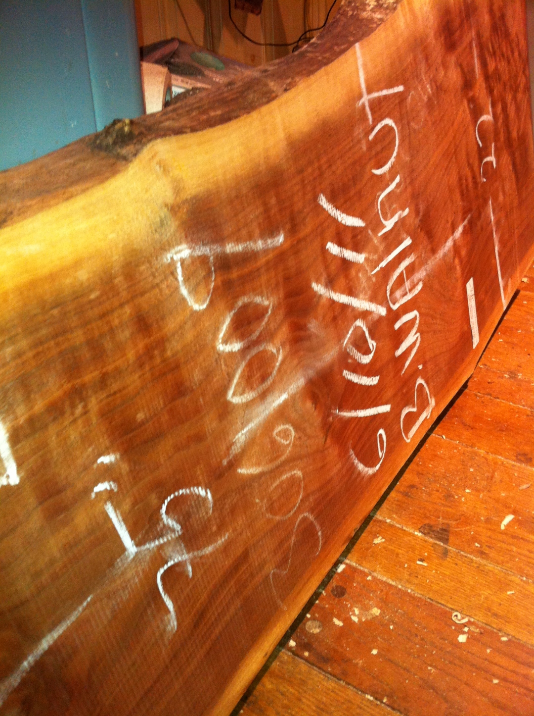 Stack of bookmatched slabs stickered for drying, live-edge cants stepped out.