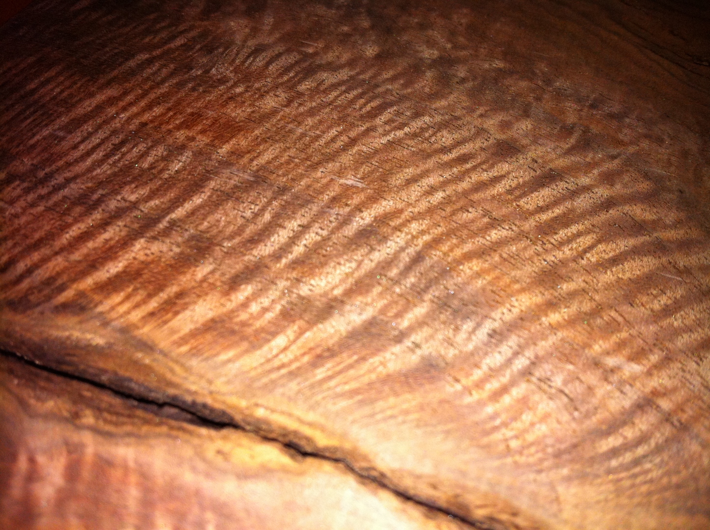 Rough curly walnut board with wide sweeping ribbon figure.