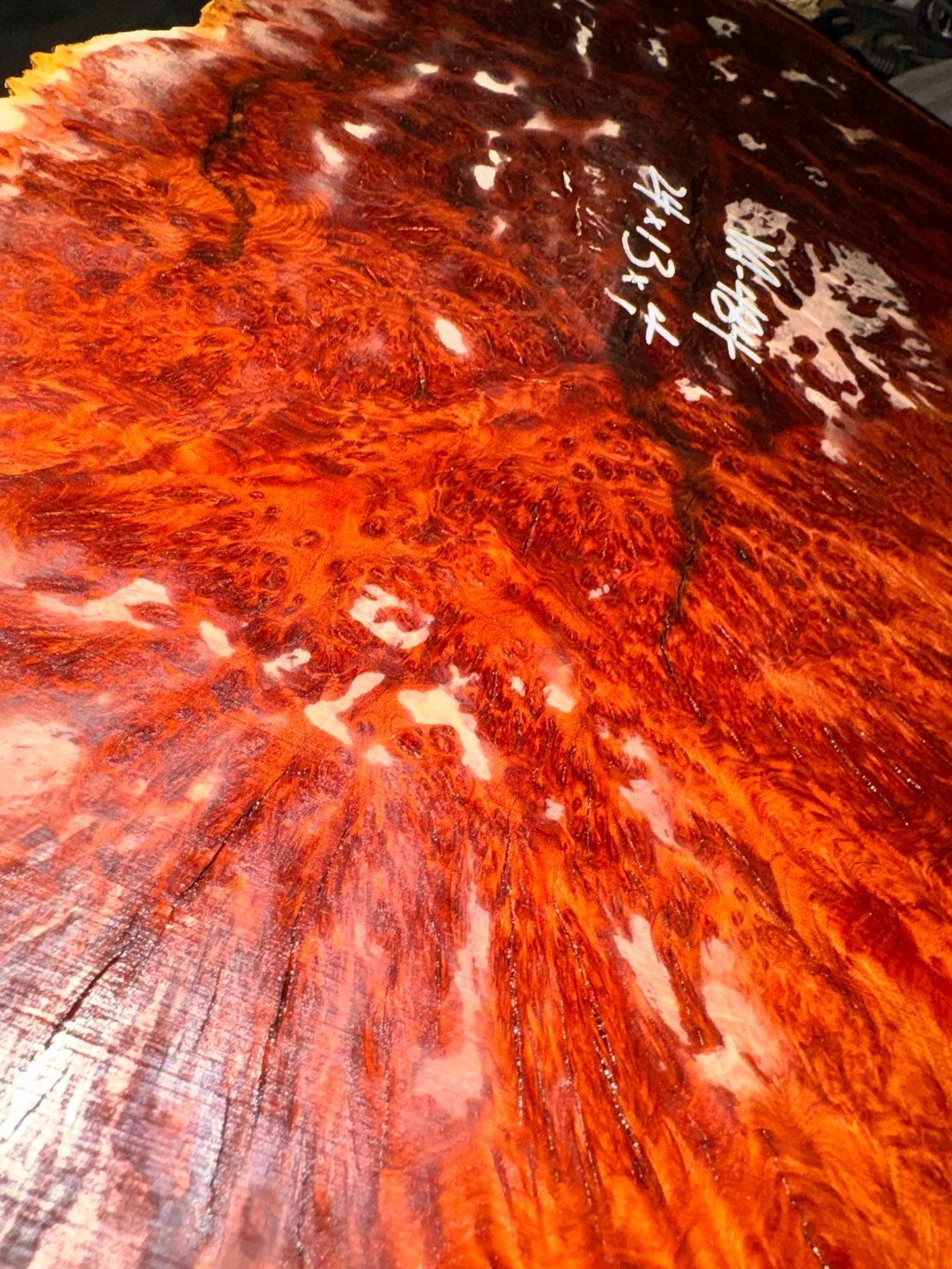 Vasticola burl closeup, deep red figure with resin void.