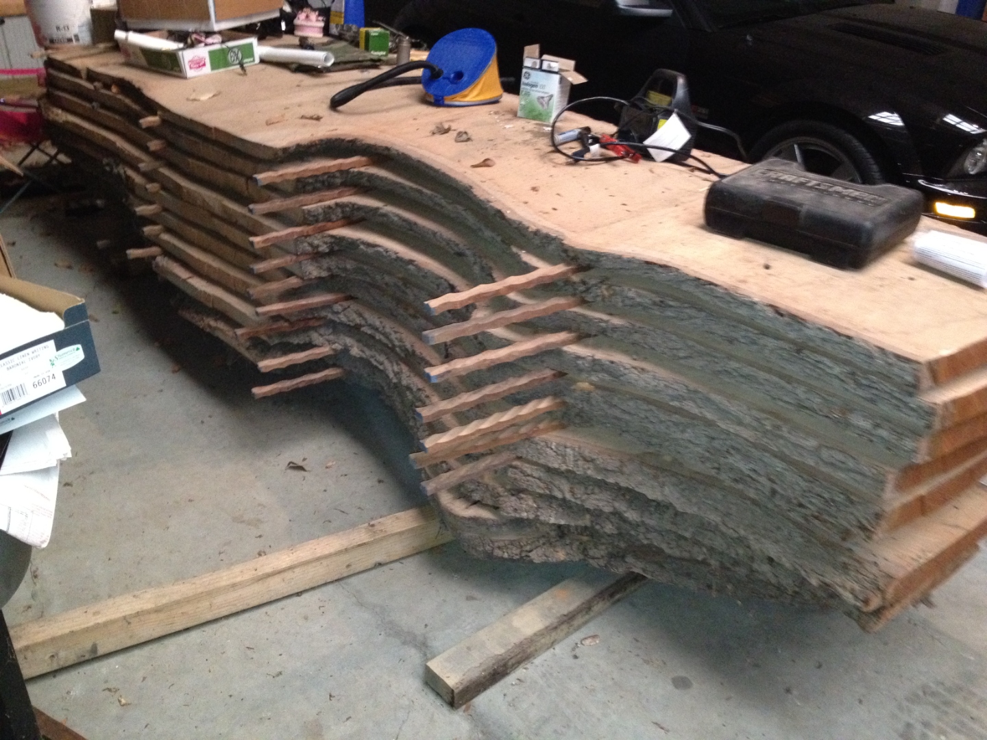 Long walnut cants stickered up for drying, bark still on.